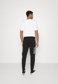 Kings Will Dream AXEL JOGGER - Calças de fato de treino - jet black