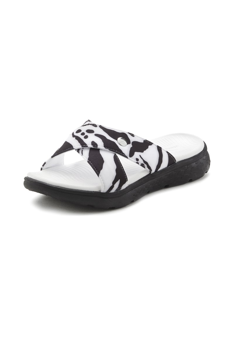 Black and white striped slide sandal with crisscross straps, rubber sole, and textured footbed. Features a metal accent on the strap.