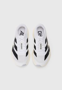 Pair of white running shoes with black stripes, lace-up closure, and "ADIZERO" printed on the tongue and insoles, viewed from above.