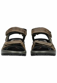 Sandali marroni con cinturini in velcro regolabili, soletta nera testurizzata e suola in gomma resistente con un motivo battistrada per una migliore aderenza.
