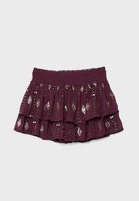 Lilla lagdelt mininederdel med elastisk taljebånd, dekoreret med sølv palietter i diamantmønster.