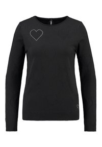 Svart långärmad tröja med upphöjda hjärtan och ett hjärta som är konturerat med små silverstift på övre vänstra sidan.