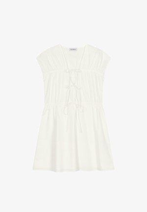 Bela bomba iz bombaža z rokavi, ki se končajo s kapico, nabranim zgornjim delom in nastavljivim vezanjem v pasu. Mehka tekstura in dolžina do kolen.