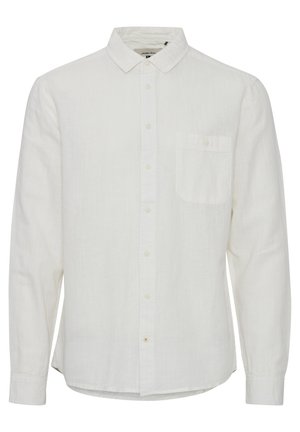 Biała lniana koszula z długim rękawem, z zapiętą kołnierzykiem, przednią kieszenią oraz subtelną teksturą. Posiada prosty dół i długie rękawy.