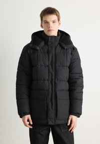 Black puffer jacket with a hood, featuring a quilted design, snap buttons, two front pockets, and a soft-textured collar.
