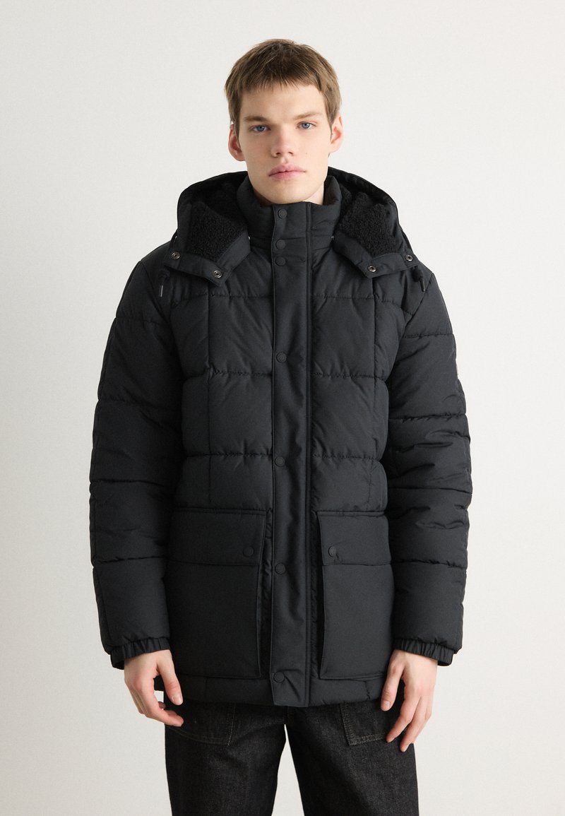 Black puffer jacket with a hood, featuring a quilted design, snap buttons, two front pockets, and a soft-textured collar.