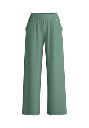 Pantalon ample à taille haute et coupe décontractée de couleur verte mate, avec poches latérales et un petit logo circulaire près de la ceinture.
