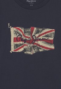 Navy blue t-shirt featuring a distressed Union Jack print with "Pepe Jeans" and "London" text in red, positioned centrally below the flag.