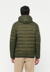 Padded olive green jacket with a hood, featuring horizontal quilted sections and a smooth texture, designed for warmth and comfort.
