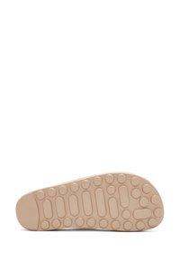Sole of a shoe, made of lightweight beige rubber. Features a textured surface with circular and oval treads for grip and traction.