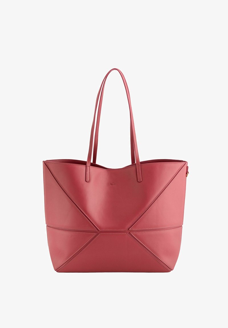 Pink leather tote bag with geometric design, featuring two long handles and stitched accents. Smooth texture with no visible hardware.