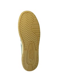 Suola di sneaker in gomma beige con un motivo a spina di pesce, dotata di un logo al centro e bordi arrotondati per stabilità e grip.