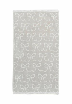 Tapis rectangulaire gris clair avec des motifs blancs en forme de nœuds répétés, reliés par des lignes courbes sur toute la surface.
