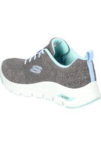 Scarpa da ginnastica grigia con tomaia in maglia testurizzata. Accenti in blu chiaro sui lacci, sulla fodera e sul tallone. Presenta un sistema di ammortizzazione ArchFit e suola bianca.