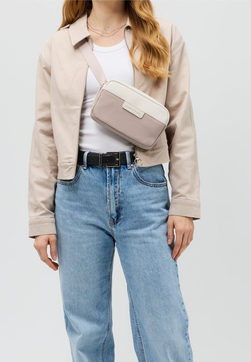 Borsa a tracolla in beige chiaro e rosa pallido con una base in tessuto texture e parte superiore liscia, dotata di chiusura con cerniera e dettagli in ecopelle.