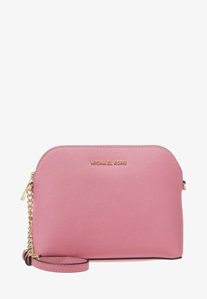 Petit porte-poignet en cuir rose avec bandoulière chaîne dorée et logo Michael Kors en lettres dorées sur le devant.