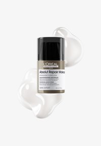 L'Oréal Professionnel Absolut Repair Molecular jätettävä hiusnaamio purkki tuotenäytteiden kanssa valkoisella taustalla.