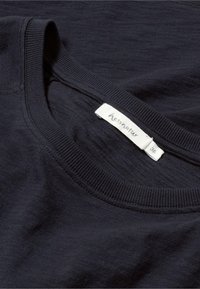 Navy blue T-shirt featuring a round neck, ribbed collar, and a textured fabric. Tag displays brand "hessnatur" and size "36."