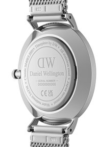 Fondo de reloj de acero inoxidable plateado con la marca, modelo y número de serie grabados. Presenta una superficie suave y bordes curvados, mostrando la fijación de la correa tipo malla.