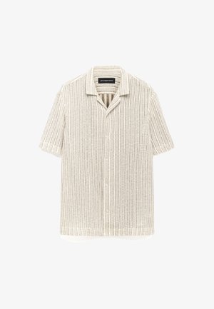 Lichtbeige shirt met korte mouwen, voorzien van een gestructureerd geribbeld ontwerp, knoopsluiting en gespreide kraag. De stof is lichtgewicht en luchtig.