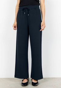 Navy blue wide-leg trousers made of soft fabric with an elastic waistband and drawstring. Features a smooth texture and straight cut.