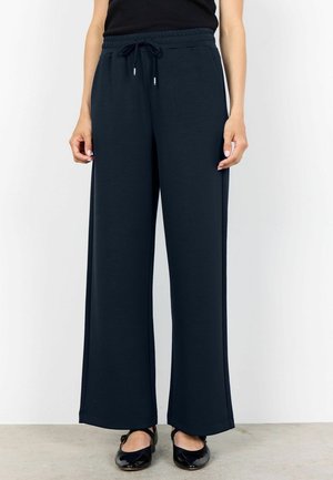 Navy blue wide-leg trousers made of soft fabric with an elastic waistband and drawstring. Features a smooth texture and straight cut.