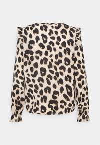 Blouse à imprimé léopard avec un fond beige et des taches noires, manches longues avec poignets froncés et ourlet droit.