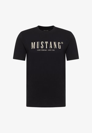 Black short-sleeve t-shirt with "MUSTANG Jeans Company Since 1932" printed in large cream font on the front center.