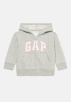 Felpa con zip grigia chiara per bambino con tasche frontali, logo "GAP" bianco contornato di rosa sul petto e cappuccio attaccato.