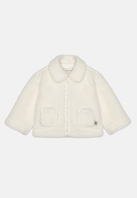 Valge, fliisist jakk koos krae, esipaneeli tõmbluku ja kahe kleebitava taskuga. Omab pehmet tekstuuri ja veidi üle mõõdu suurust.