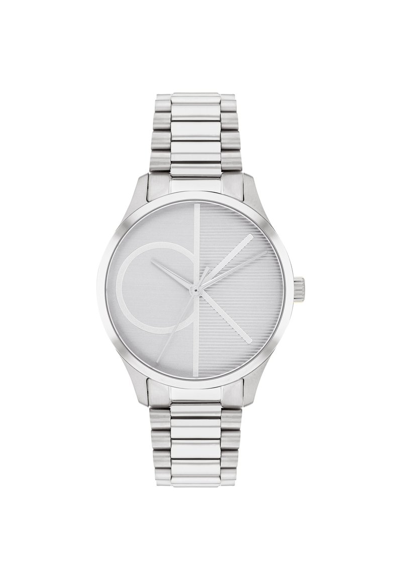 Reloj de acero inoxidable plateado con una esfera redonda, que presenta una esfera gris texturizada, un bold logo de CK y una pulsera de eslabones de metal.