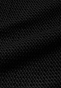 Tissu noir texturé avec un motif tissé comportant des formes arrondies en relief, créant une surface douce et tactile.
