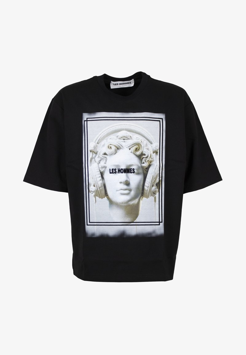 Black t-shirt with white bust sculpture wearing large headphones and "LES HOMMES" text across the sculpture's eyes inside a double-lined border.