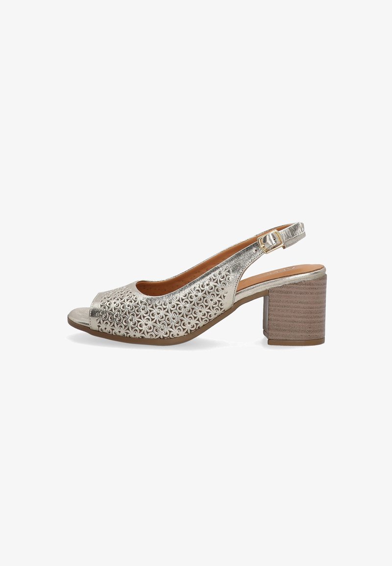 Metallic silver slingback shoe with an open toe, intricate cut-out pattern, and a textured block heel in a natural wood finish.