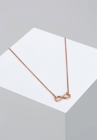 Rose gold infinity halskæde på en delikat kæde. Har et glat, poleret design med en fin tekstureret kæde.