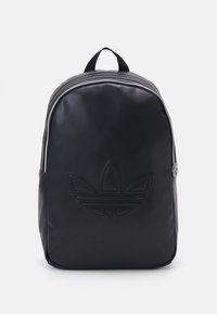 Black backpack made of smooth material. Features a textured logo print, dual top zippers, and a fabric carry handle on top.