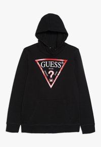 Hoodie noir avec un graphique triangulaire rouge et blanc sur le devant, comportant « GUESS® » et un point d'interrogation. Inclut une poche avant.