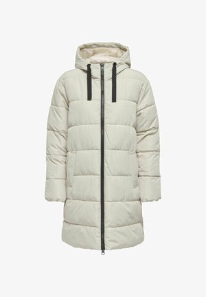 Vaatteena on vaahtoarvoinen parka-takki, vaaleanbeige, hupullinen, edessä vetoketjulla, mustilla nyöreillä ja kahdella sivutaskulla, jossa on tikattu rakenne.