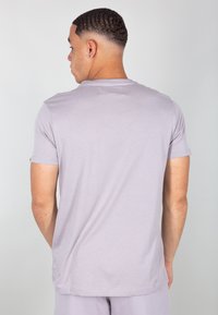 T-shirt grigio chiaro a maniche corte realizzato in tessuto morbido, con taglio classico e scollatura rotonda; texture liscia e design minimale.