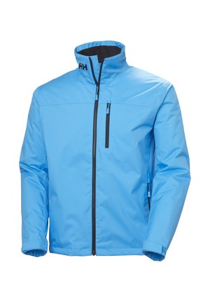 Light blue jacket with a high collar, black zippered pockets, and a smooth, textured surface. Features brand logo on the collar.