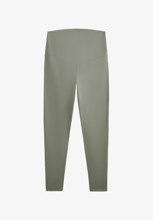 Vihreät leggingsit, joissa on korkea ja leveä vyötärö. Valmistettu sileästä, joustavasta kankaasta. Suunniteltu tiukasti istuvaksi ilman näkyviä saumoja.