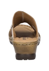 Tan leather sandals with an open back, adjustable strap, and a textured footbed; features a slight heel and wood-like pattern on the sole.
