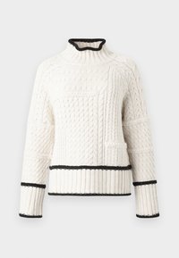 Krämfärgad stickad tröja med hög krage, texturerade mönster och svart kant vid halsen, ärmarna och nederkanten. Har en framficka.