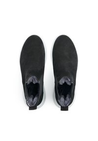 Black suede ankle boots with a plush gray interior, rounded toes, and white rubber soles, featuring pull tabs for easy wear.