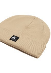 Beige knit beanie with vertical ribbing, fold-over cuff, and a black rectangular logo patch featuring a mountain design.