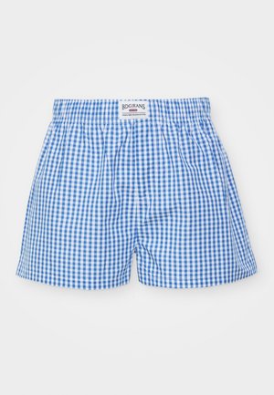 Zili un balti svītraini bokseršortus ar elastīgu jostu un logo etiķeti. Izgatavoti no viegla auduma ar brīvu piegriezumu.