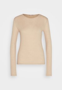 Haut beige ajusté à manches longues avec col rond et texture côtelée, présenté sur un fond gris clair uni.