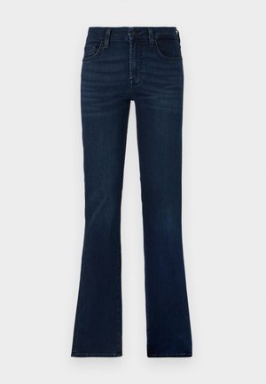 Jean évasé bleu foncé en denim. Présente cinq poches, une fermeture à bouton et un léger dégradé sur les cuisses.