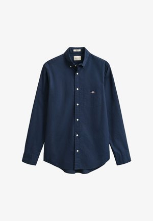 Camicia a maniche lunghe blu navy in cotone con collo button-down e taschino sul petto a sinistra. Presenta chiusure con bottoni bianchi e un dettaglio logo discreto.