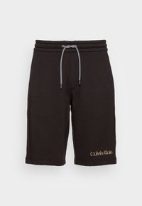 Pantaloni corti in cotone neri con cintura elasticizzata e cordino, tasche laterali e logo giallo ricamato "Calvin Klein" sul fronte.